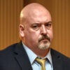 Virginia House Minority Leader and state Del. Todd Gilbert in a black suit and yellow tie